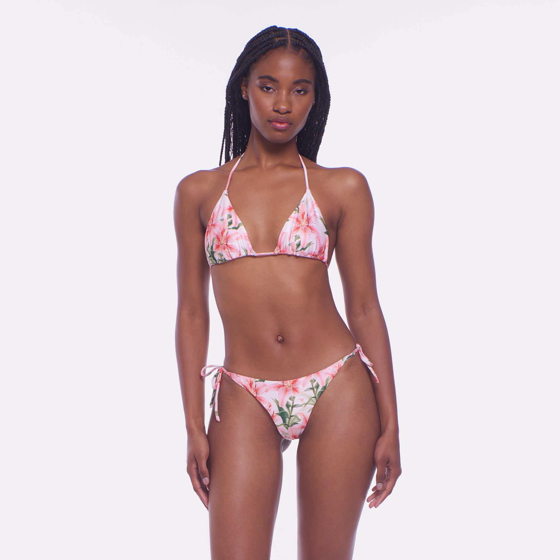 Woman wearing a floral bikini set on a white background