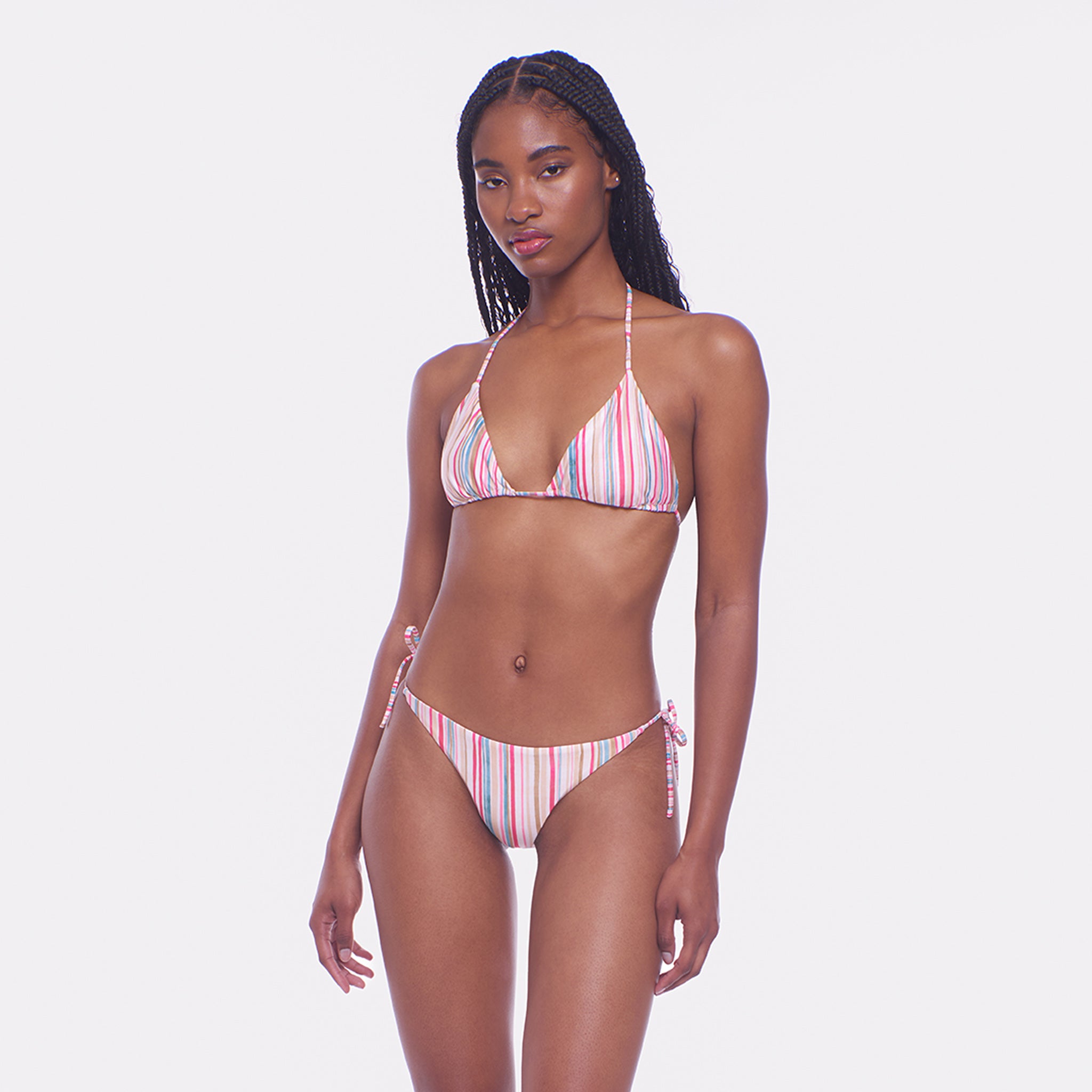 Woman wearing a striped bikini on a white background