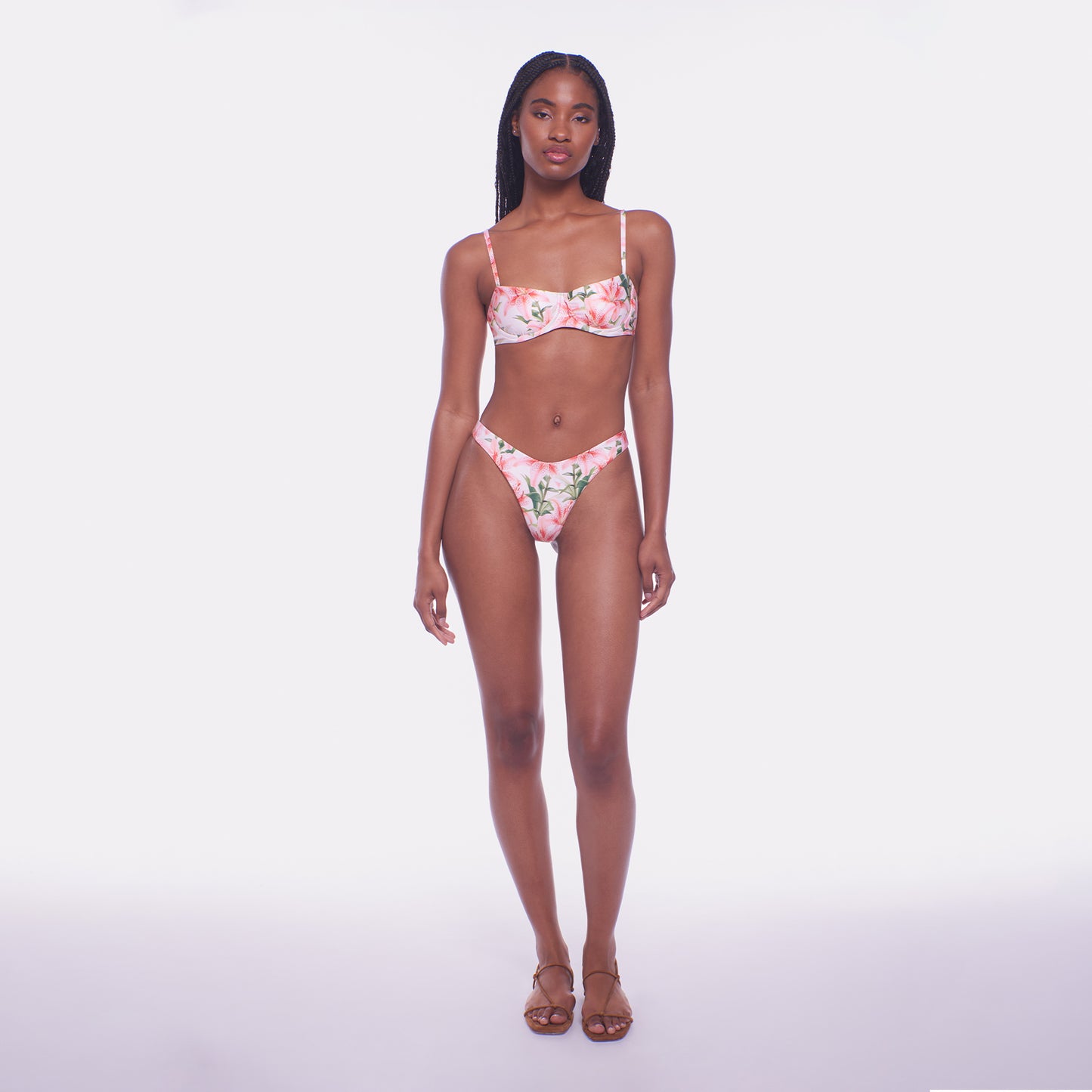 Woman wearing a floral bikini set on a white background