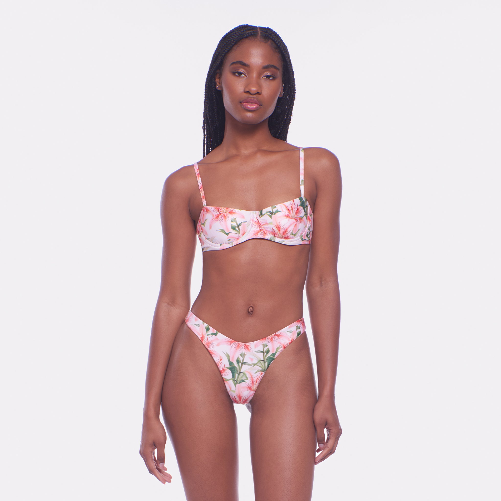 Woman wearing a floral bikini set on a white background
