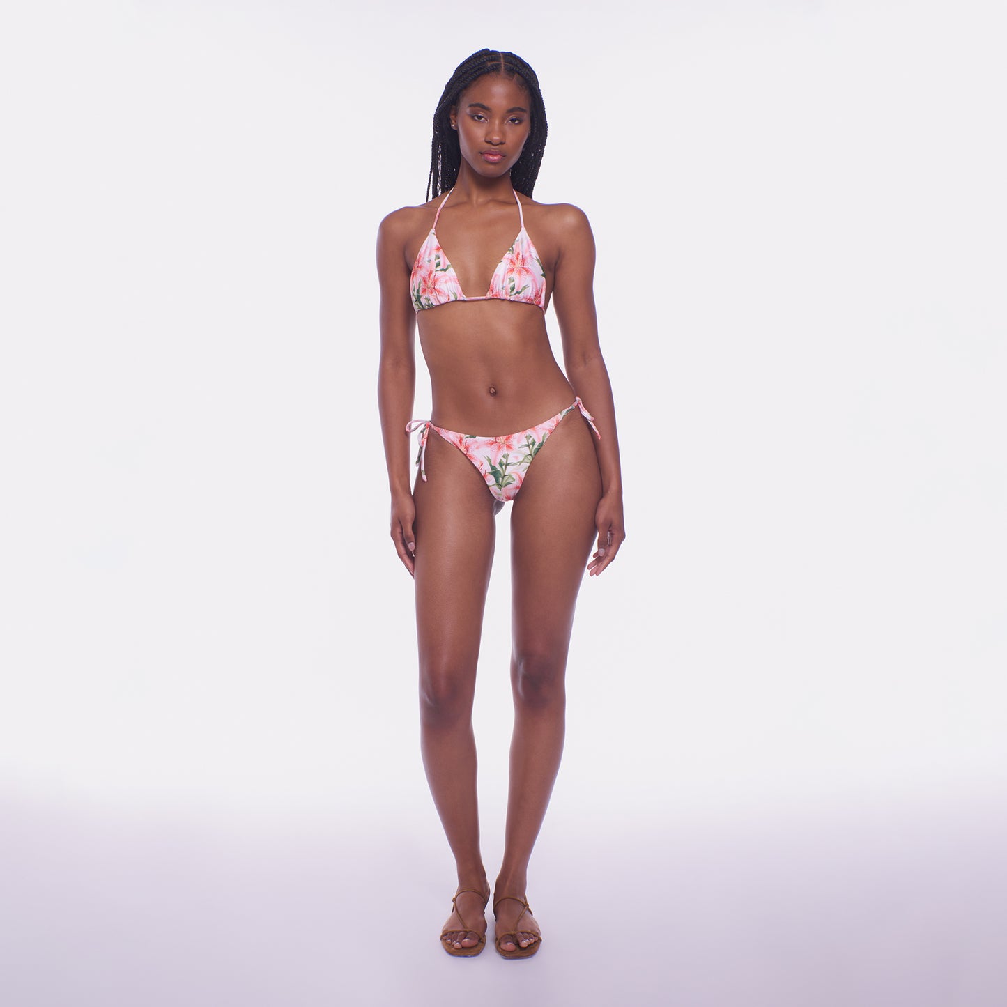 Woman wearing a floral bikini set on a white background