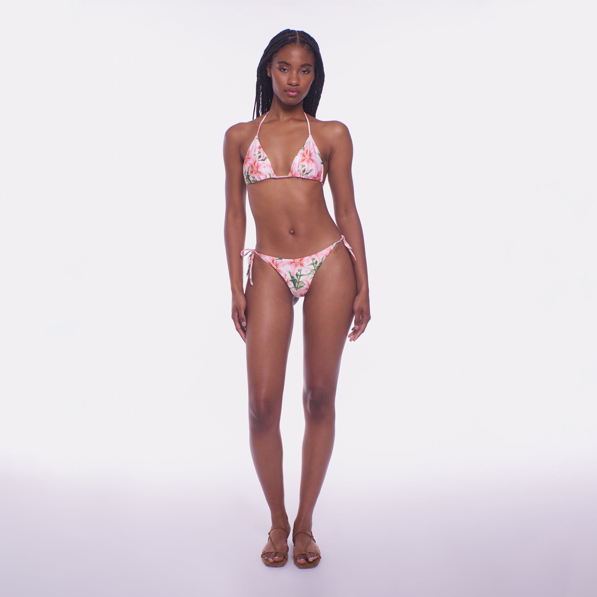 Woman wearing a floral bikini set on a white background