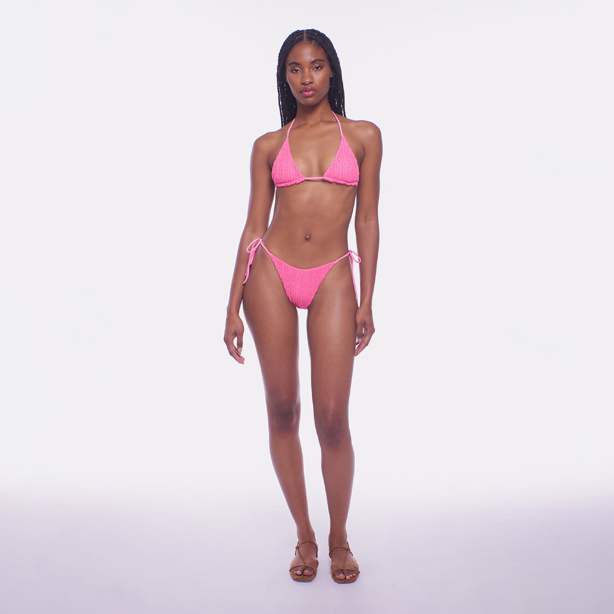 Woman wearing a pink bikini on a white background