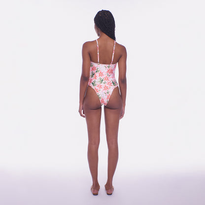 Woman wearing a floral swimsuit on a white background