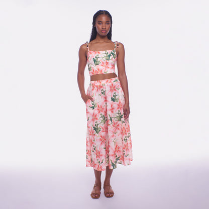 Woman wearing a floral two-piece outfit on a white background