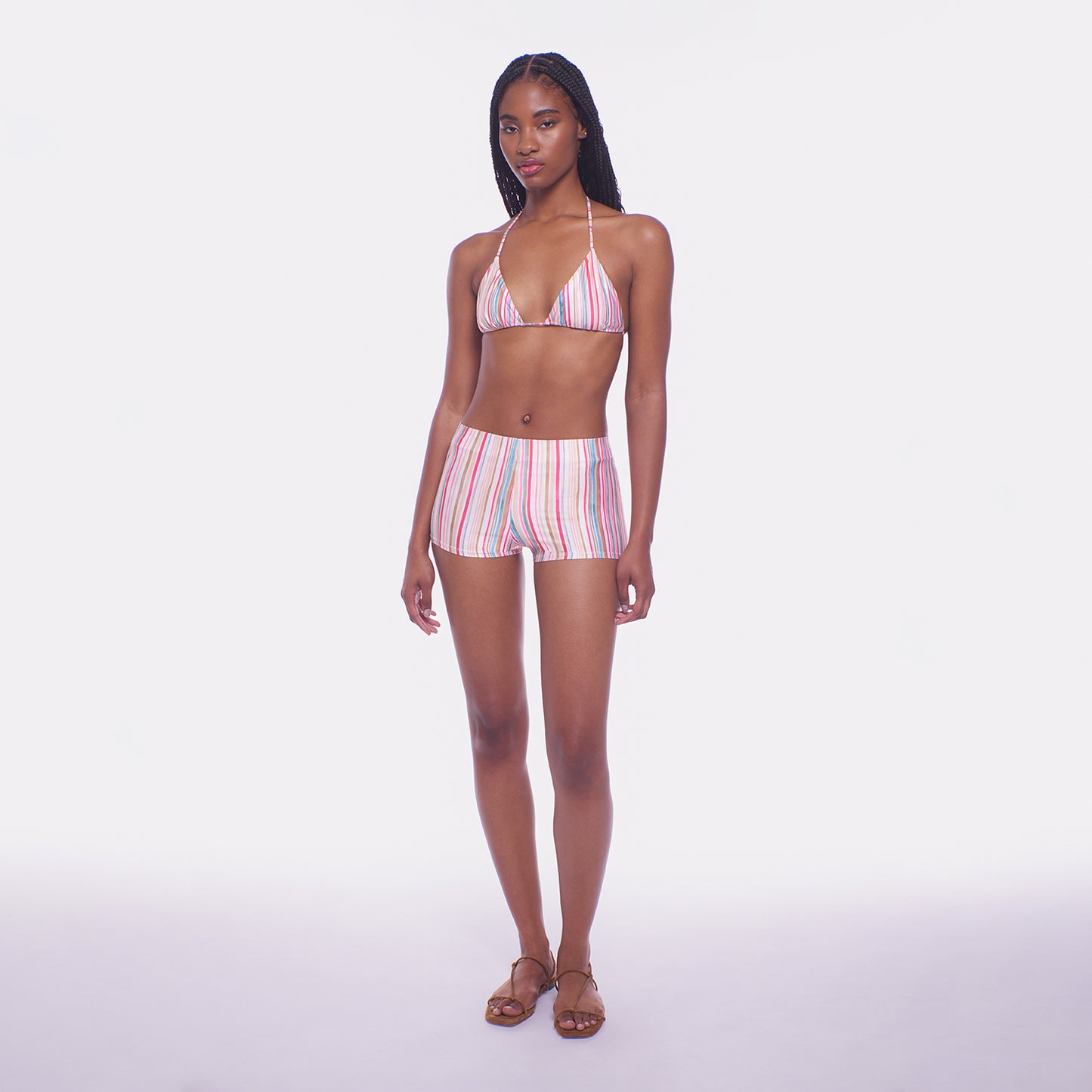 Woman wearing a striped bikini set on a white background