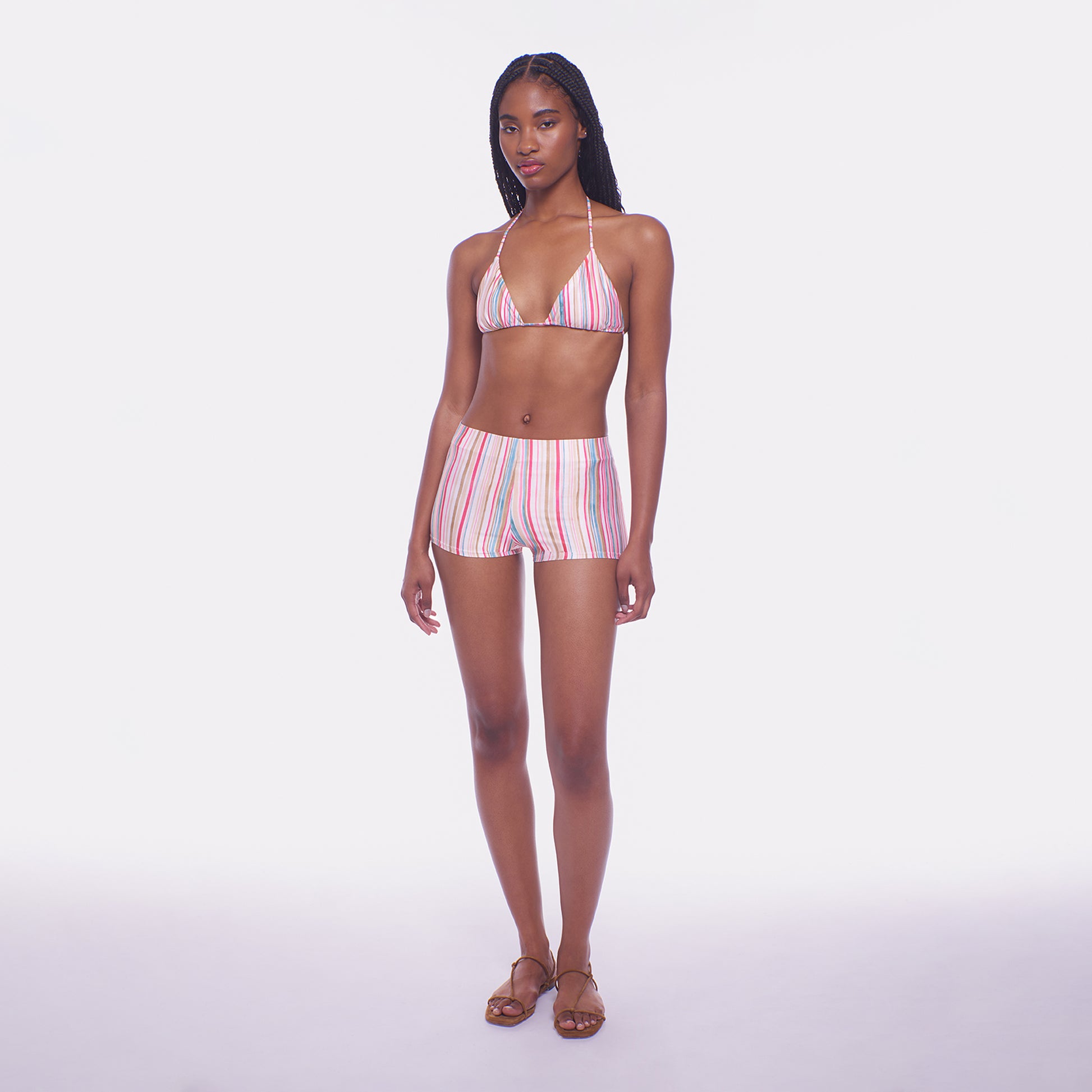 Woman wearing a striped bikini set on a white background