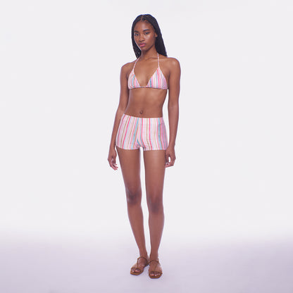 Woman wearing a striped bikini set on a white background