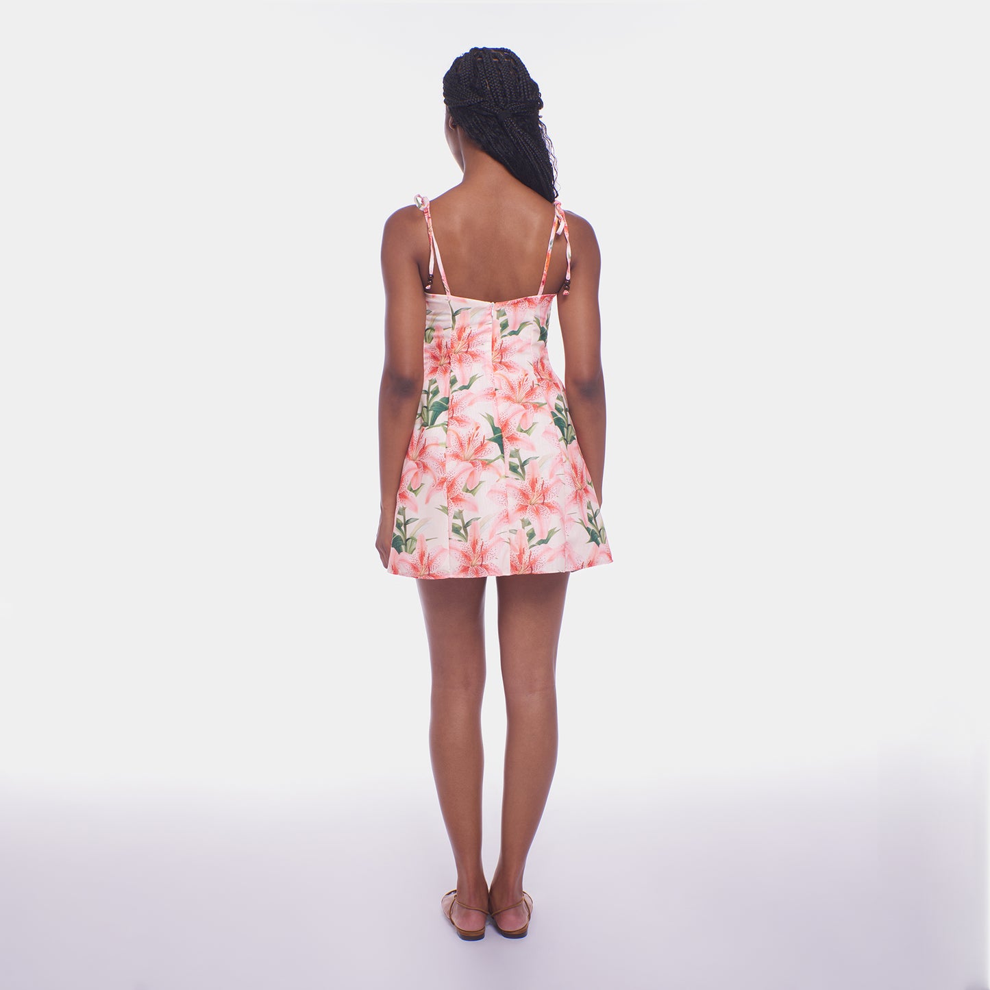 Woman wearing a floral dress on a white background