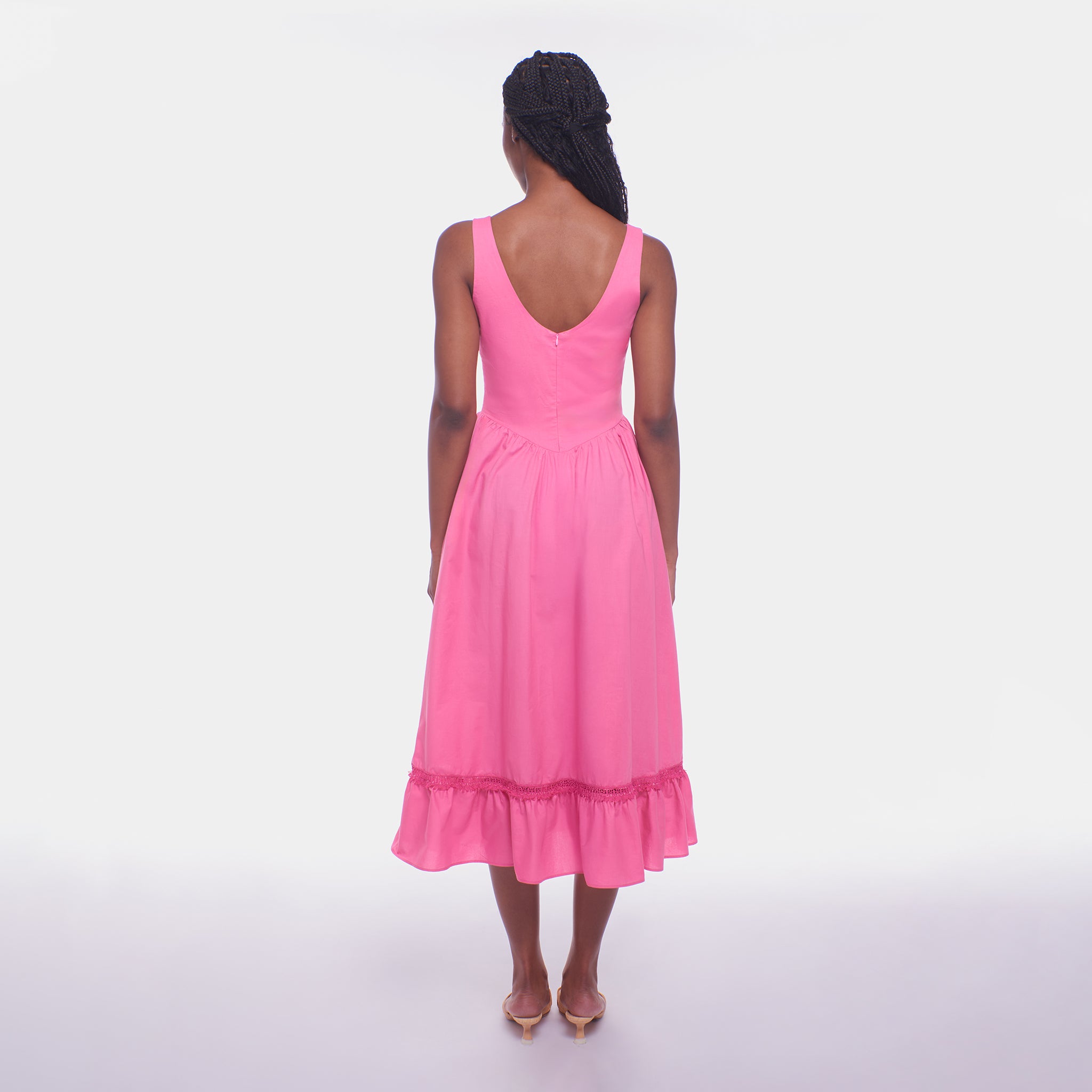 Woman wearing a pink dress on a white background