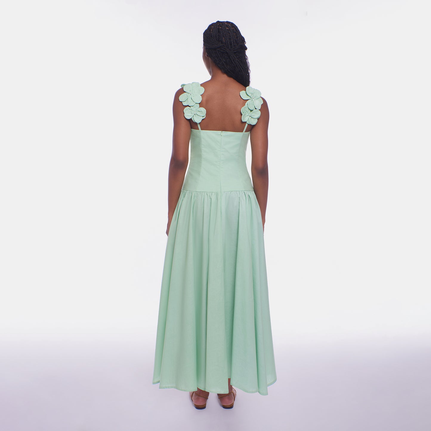 Mint green dress with floral shoulder straps on a white background