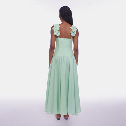 Mint green dress with floral shoulder straps on a white background